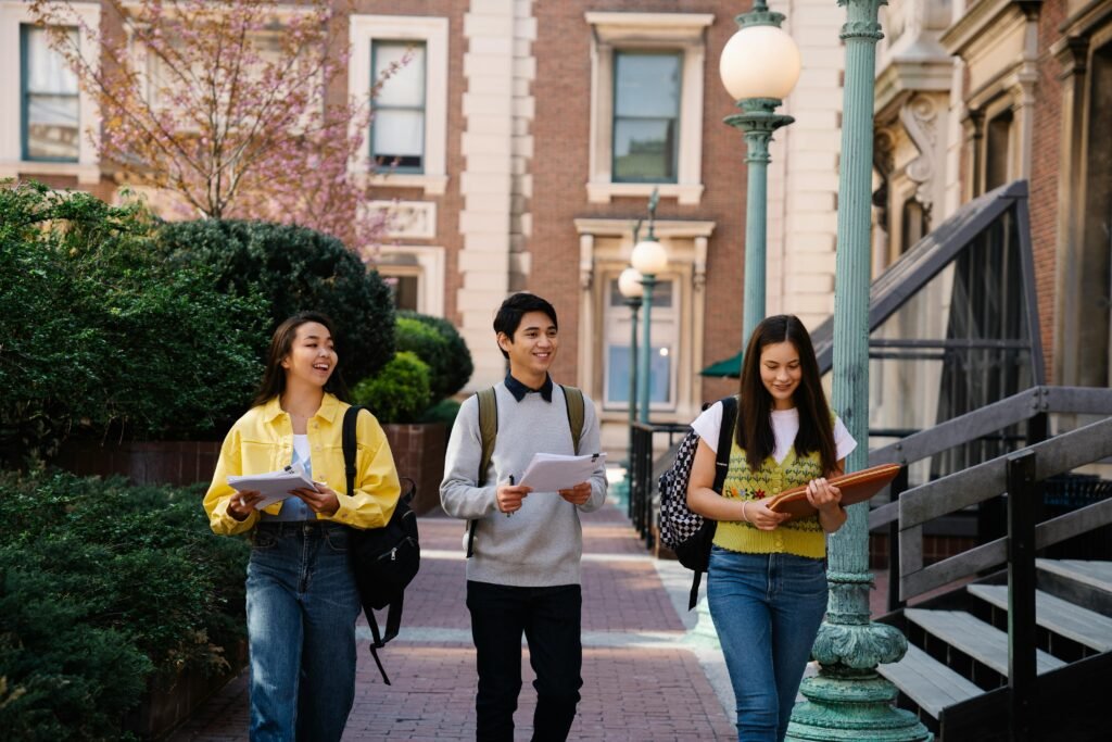 college students carrying cotton tote bags campus